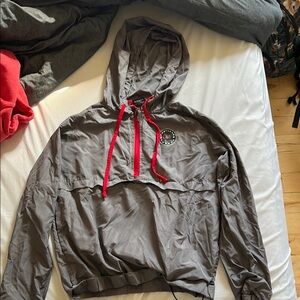 Portland thorns Gray Hooded Windbreaker with Red Accents comes with built in bag